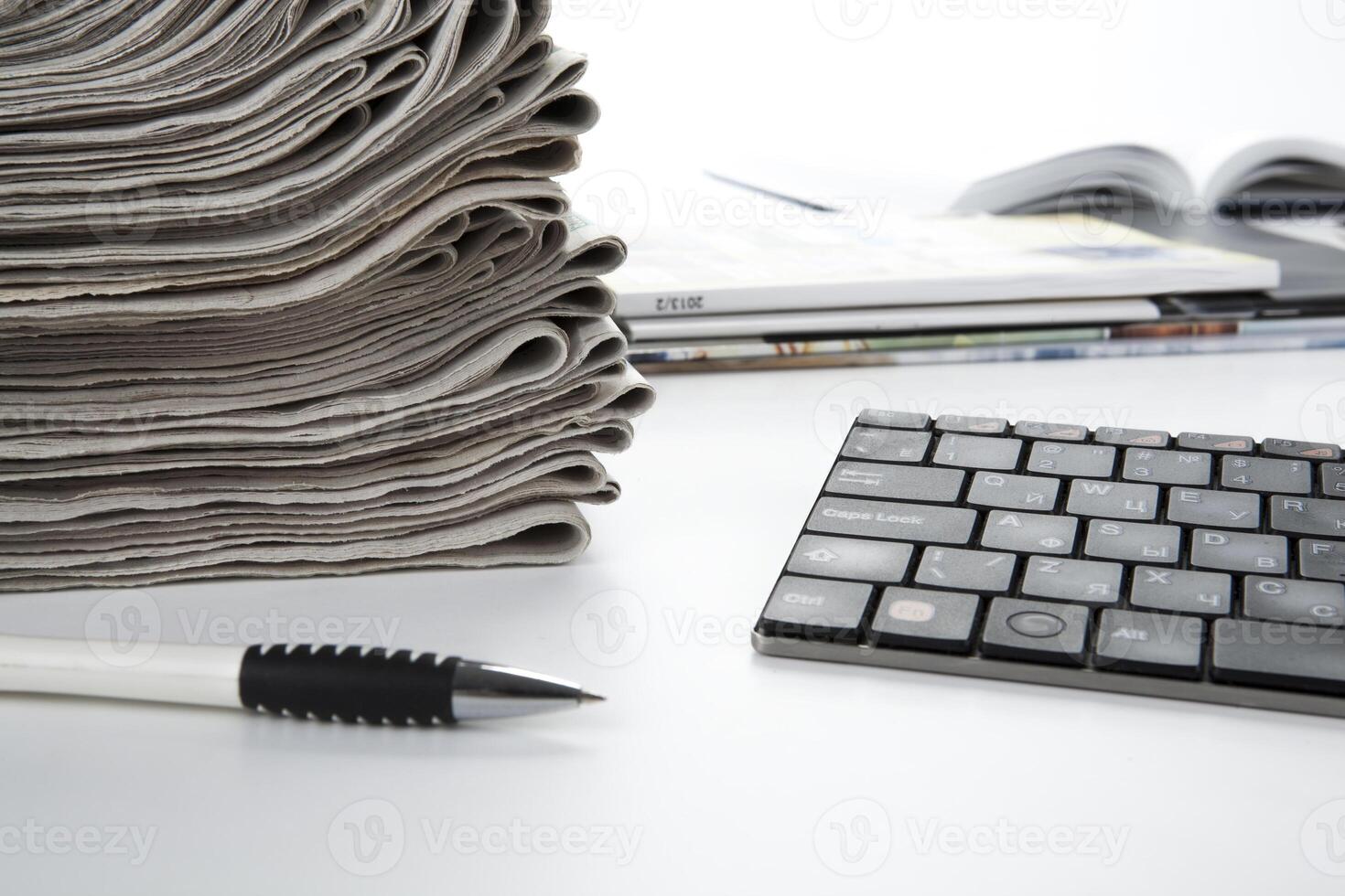 stack of newspapers and keyboard photo