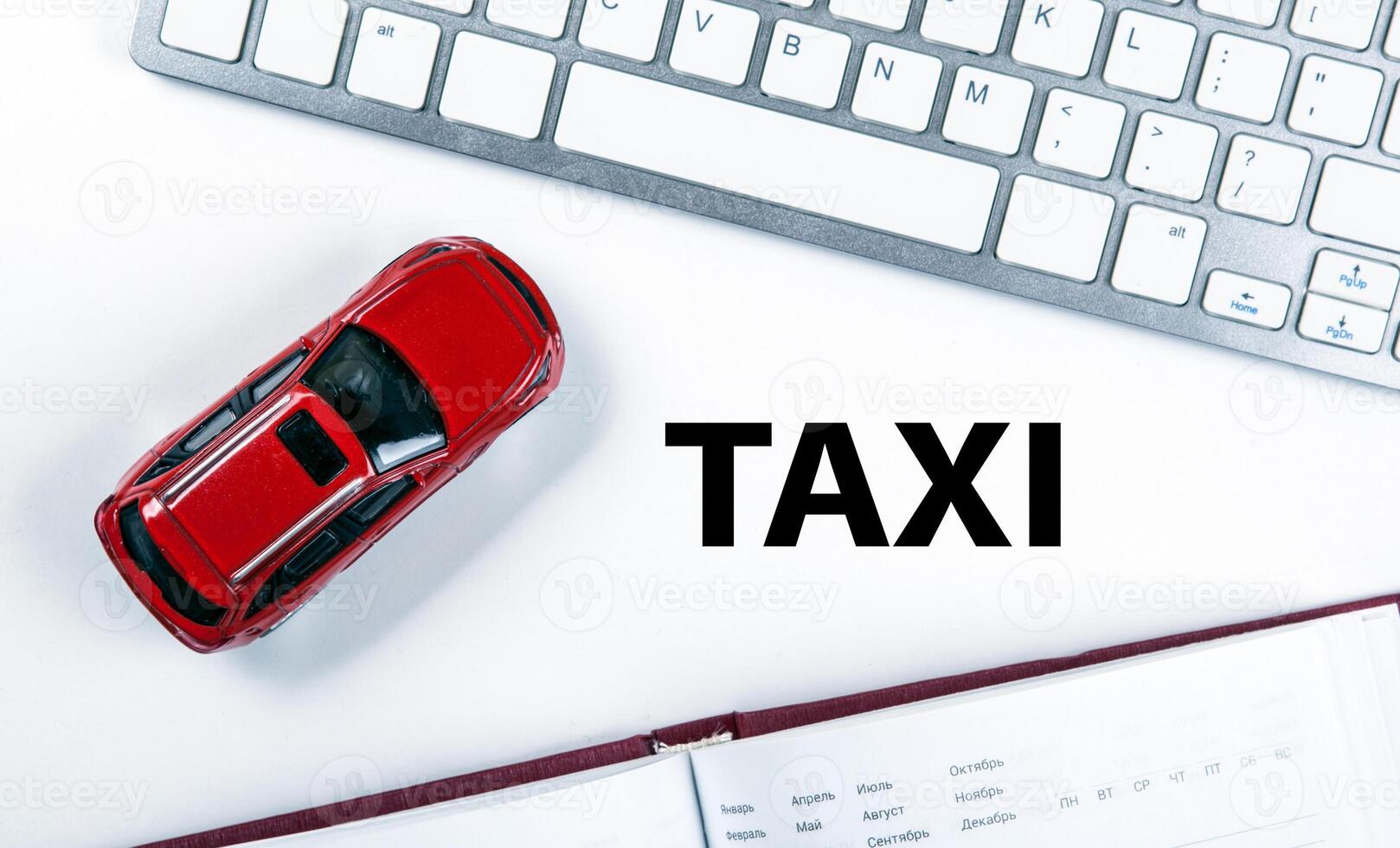 red car model near the keyboard in the concept of calling a taxi photo