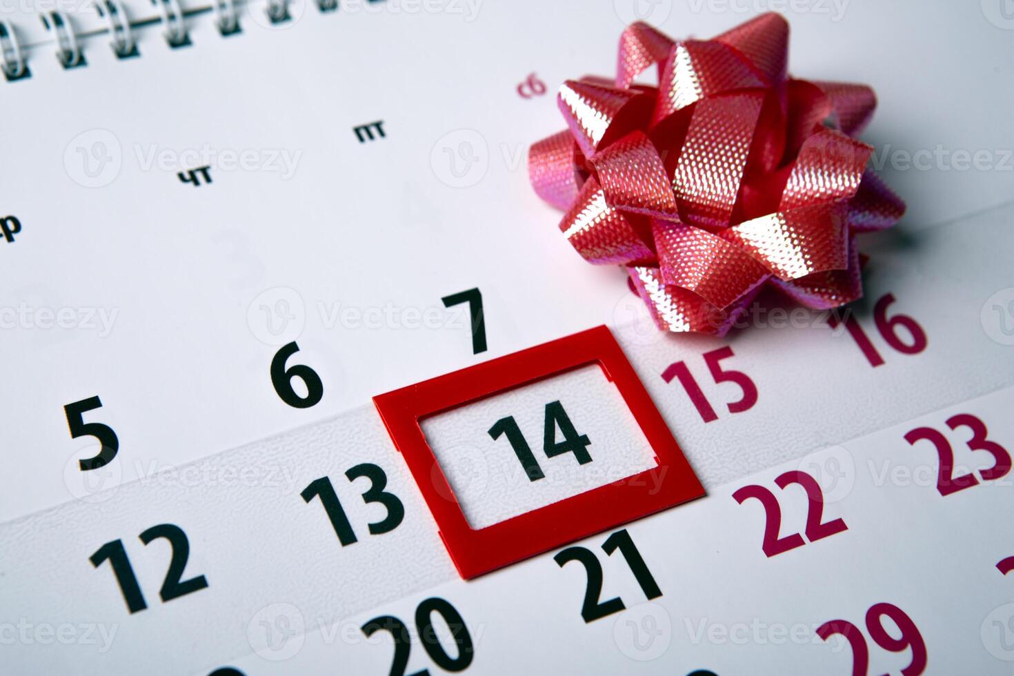 wall calendar with day 14 february and festive bow close up photo