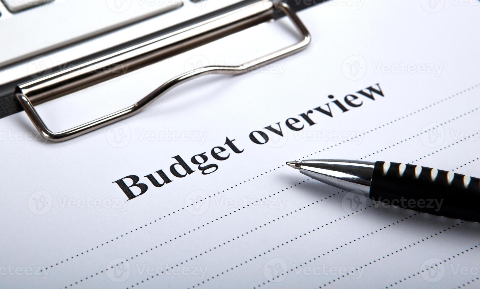 document with title budget overview and pen photo
