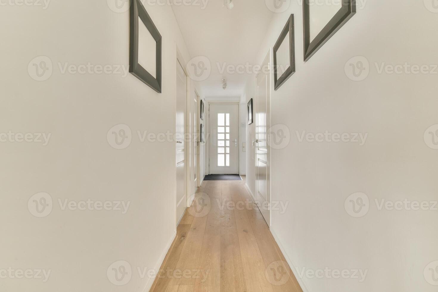 Hallway with wooden floor and white walls photo