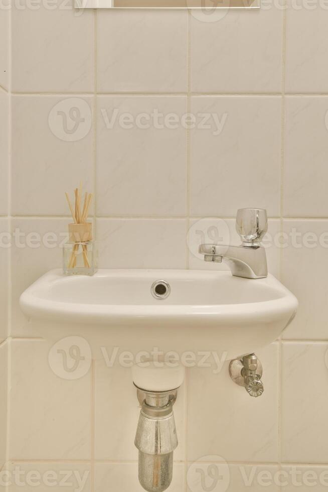 A bathroom sink with a mirror above it photo