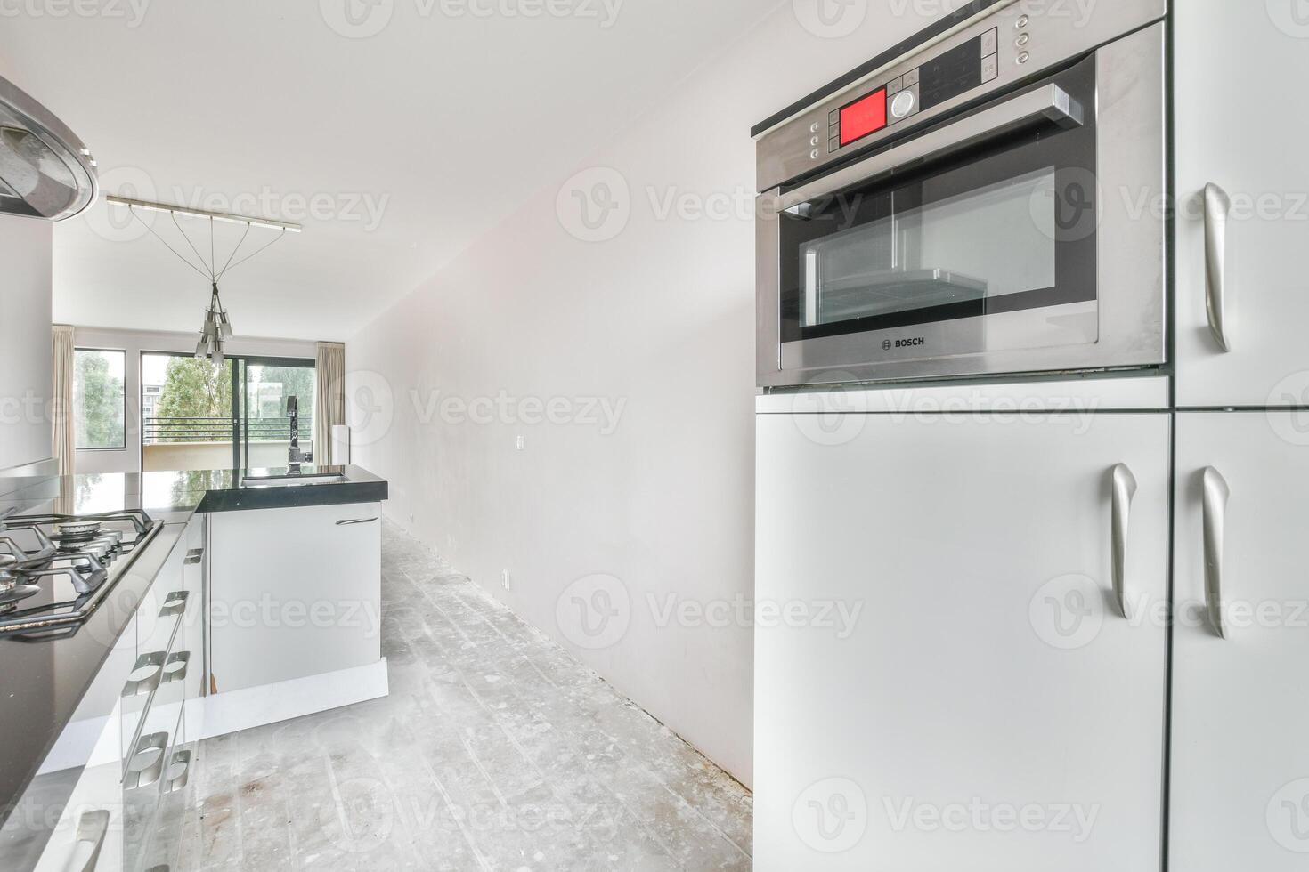 A kitchen with a microwave oven and a refrigerator photo