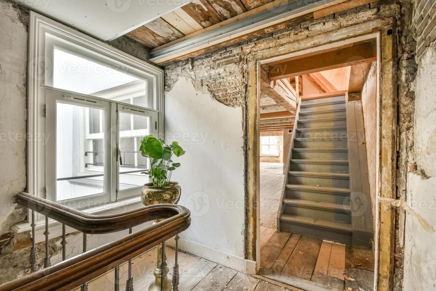 A stairway leads to a room with a window photo