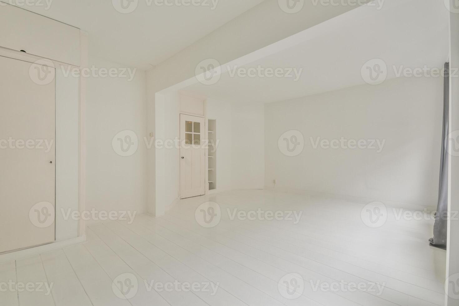 A white room with a door and a white floor photo