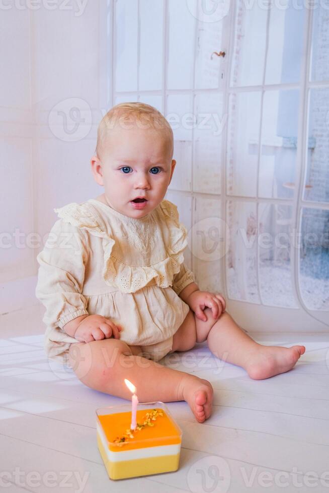 Baby girl celebrating her birthday with birthday cake photo
