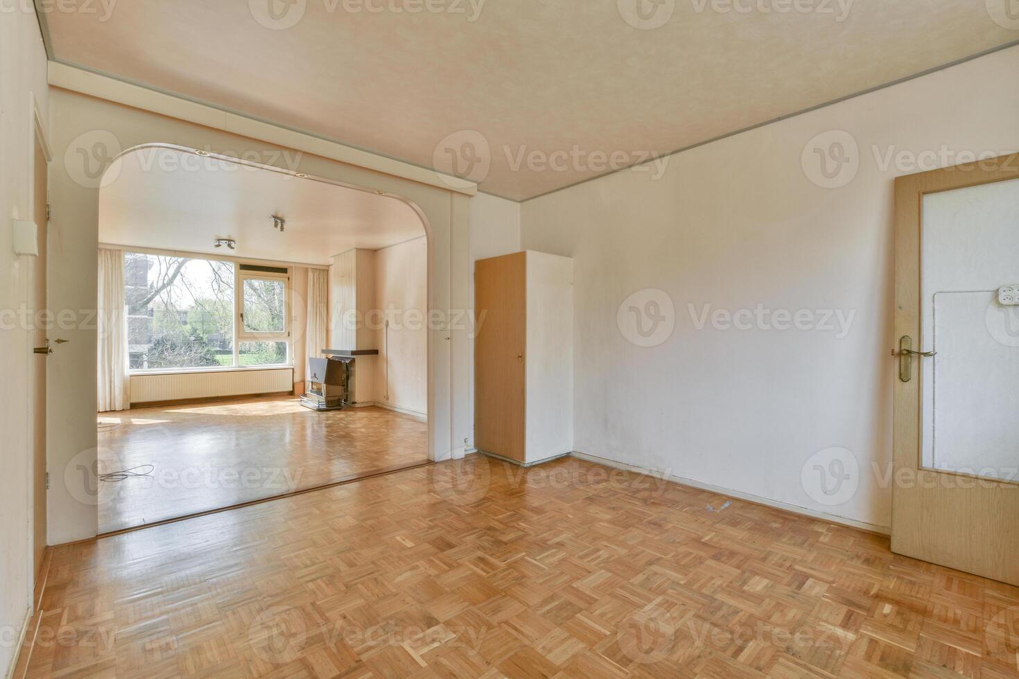 An empty room with wooden floors and a door photo