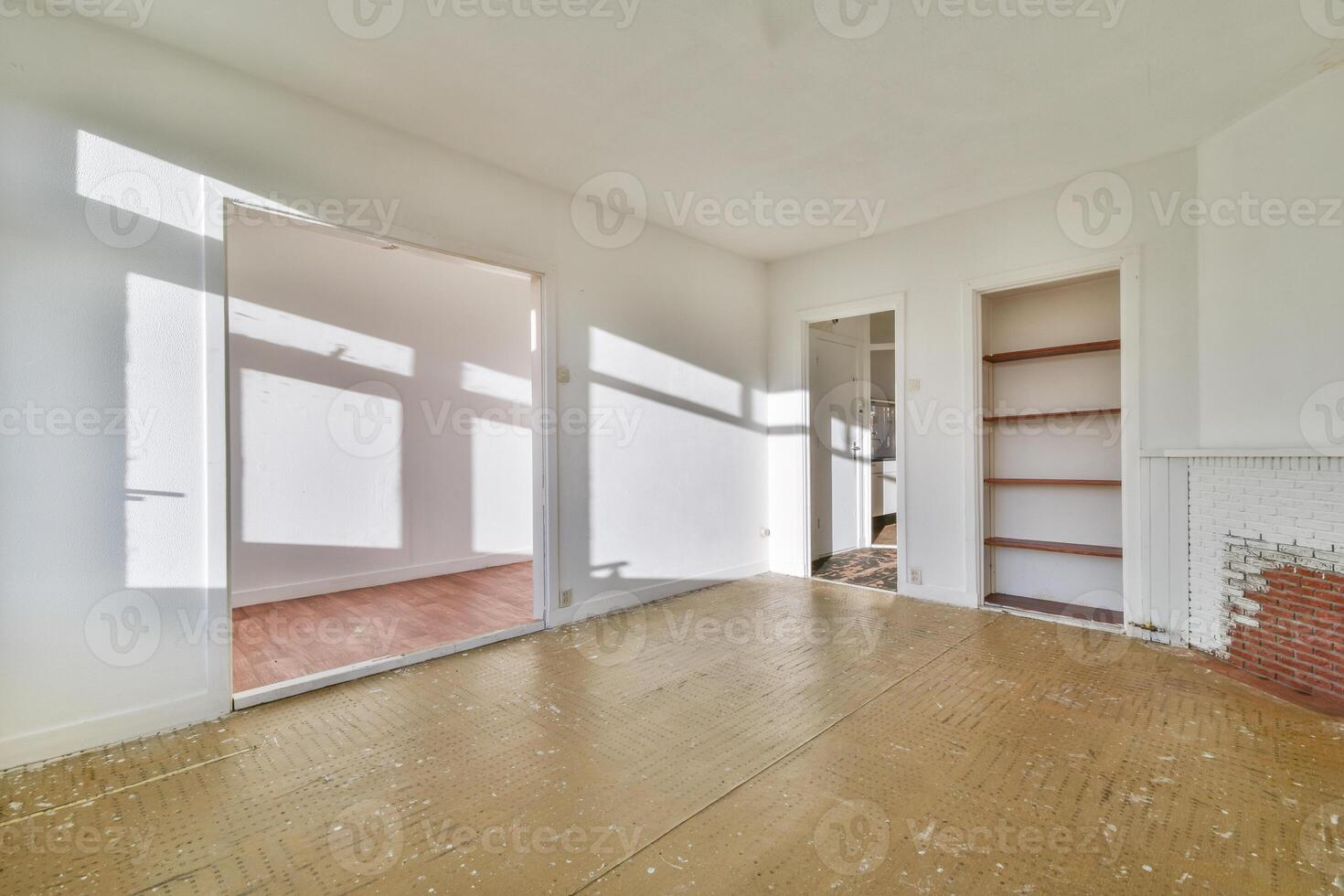 An empty room with a fireplace and wooden floors photo