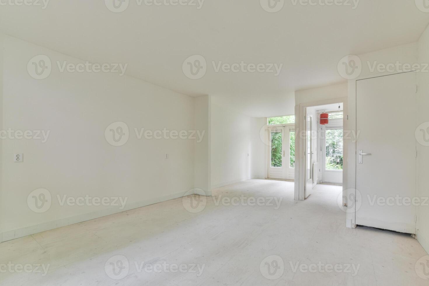 A white room with a door and a window photo