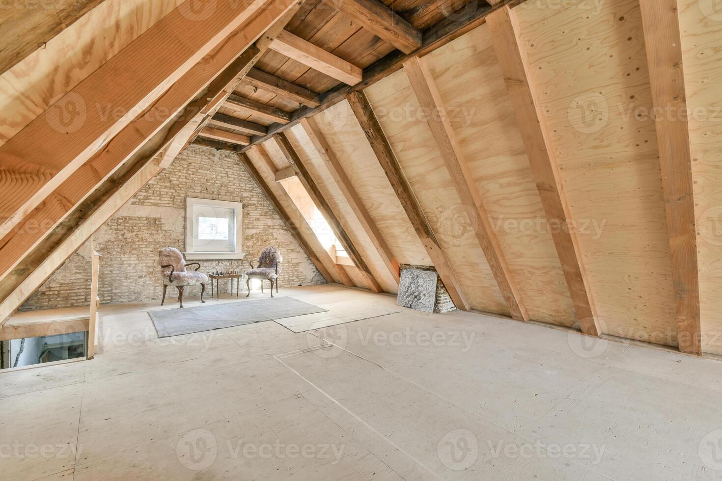An attic with a wooden floor and a table photo