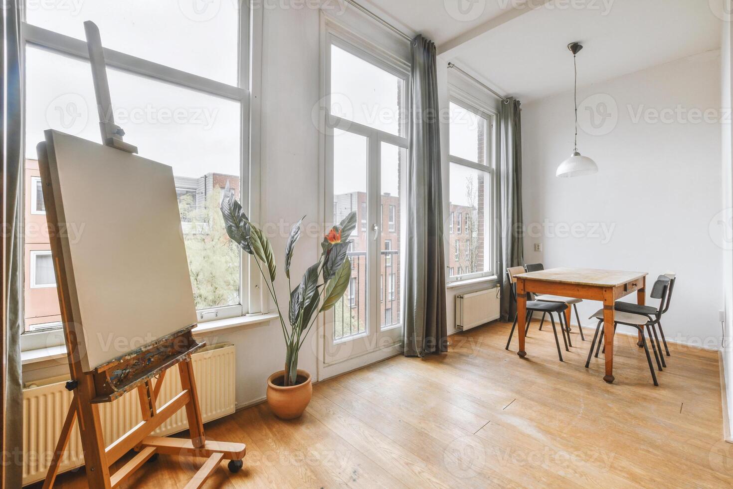 A room with a table, chair and easel photo