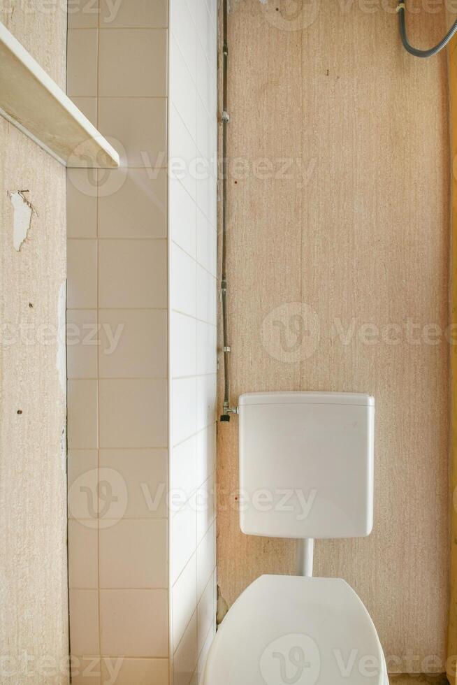 A bathroom with a toilet and a shelf photo