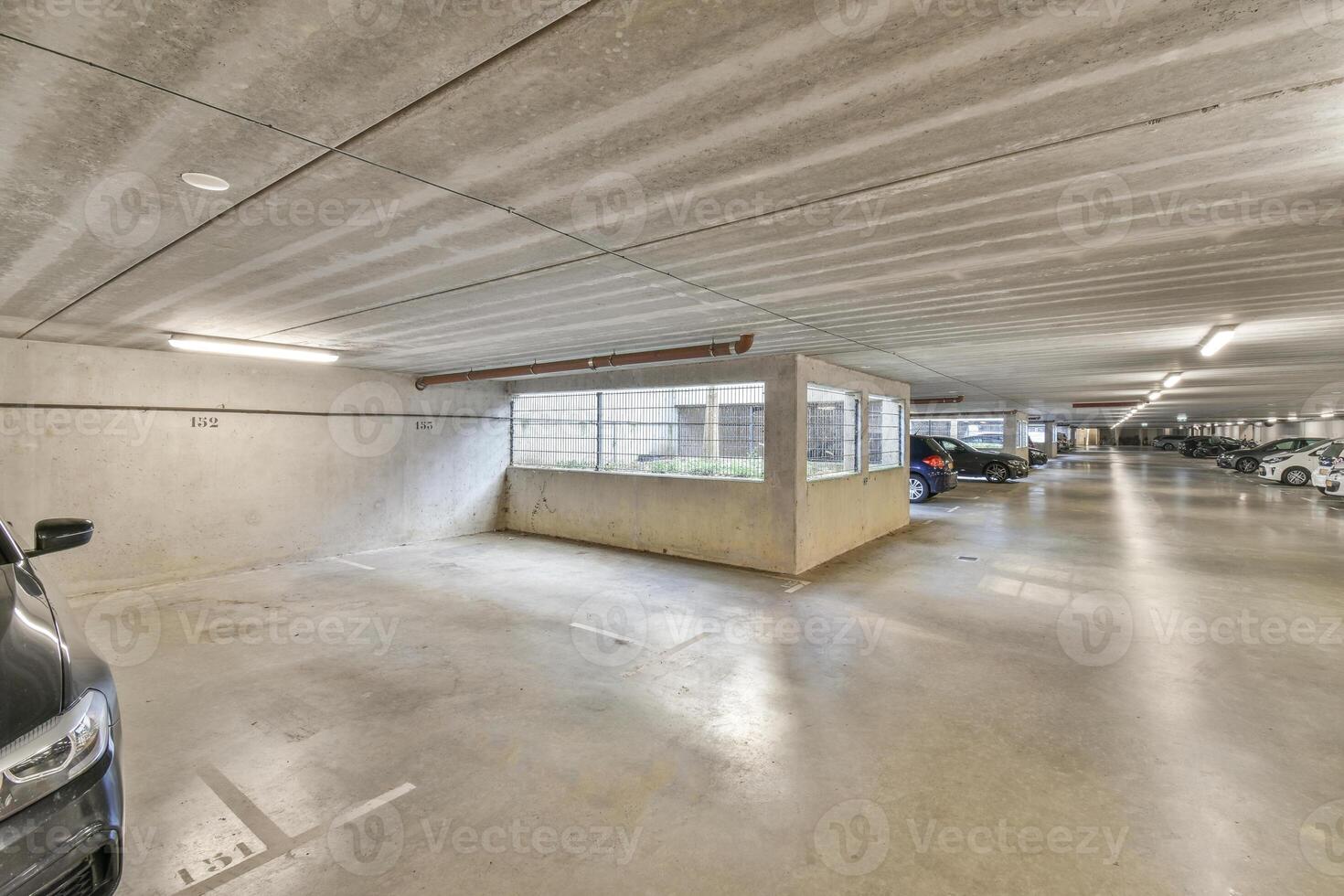 An empty parking garage with two cars parked inside photo
