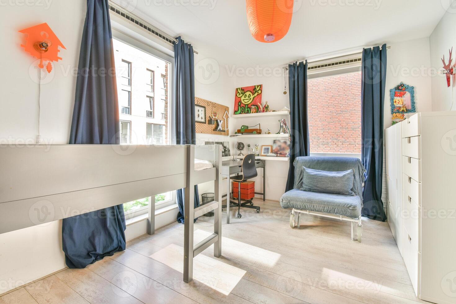A bedroom with a bed, desk, and window photo
