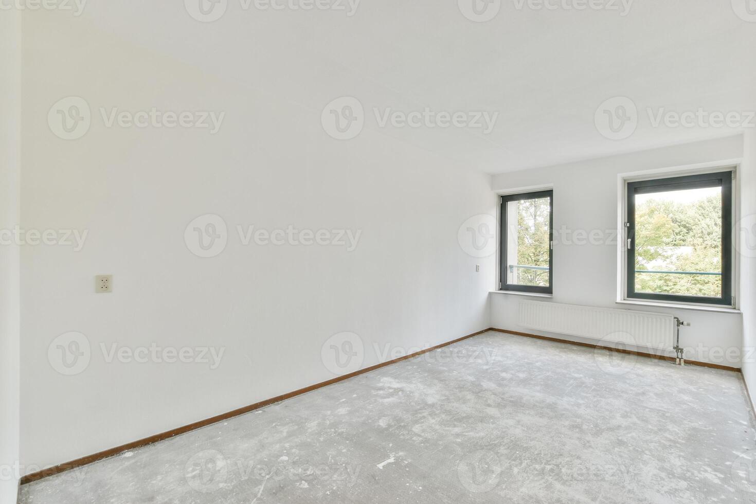 Empty room with large windows and white walls photo