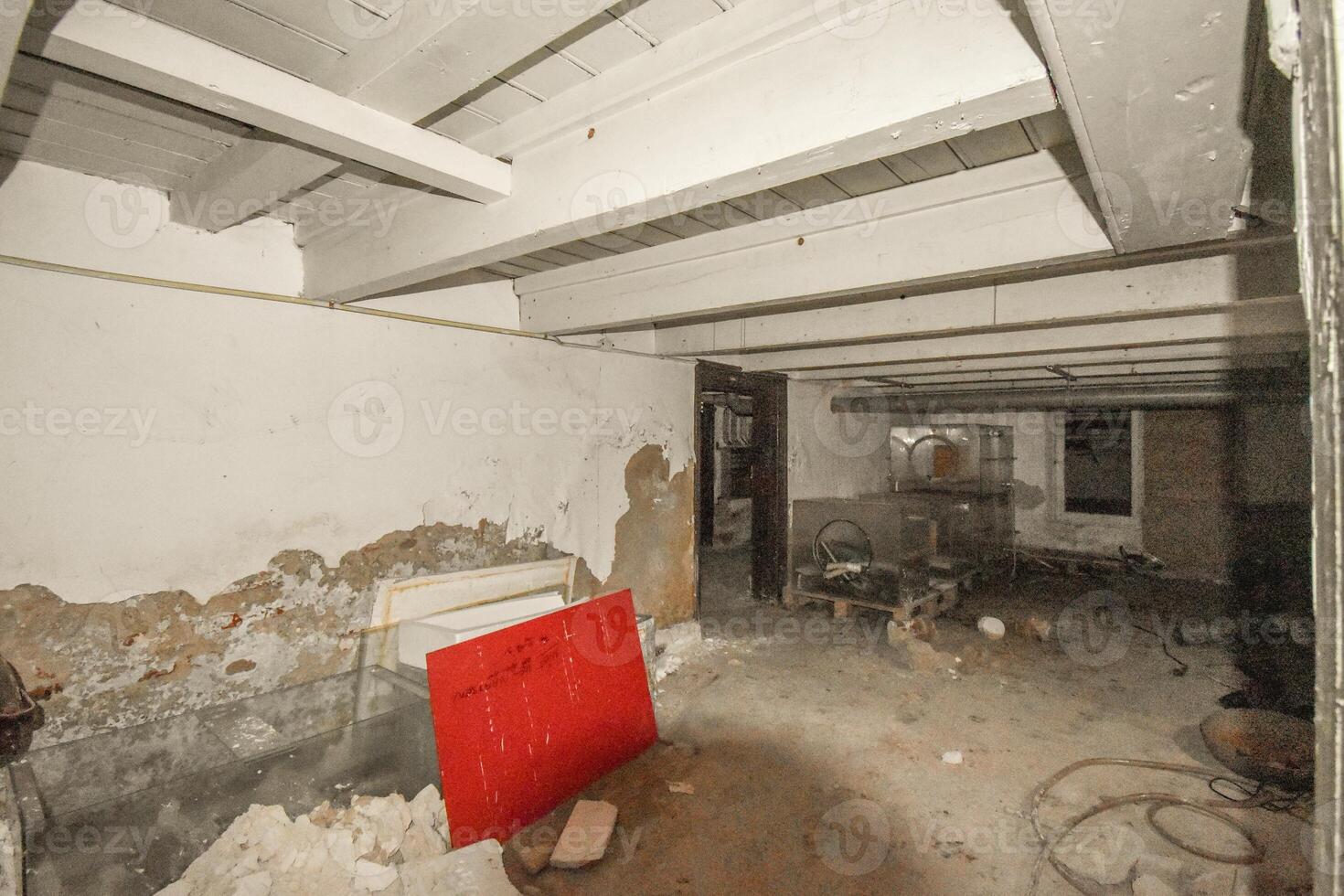 A kitchen with a red refrigerator in the middle of a room photo