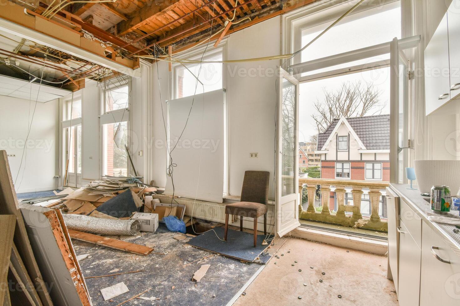 A kitchen with a window and a lot of debris photo