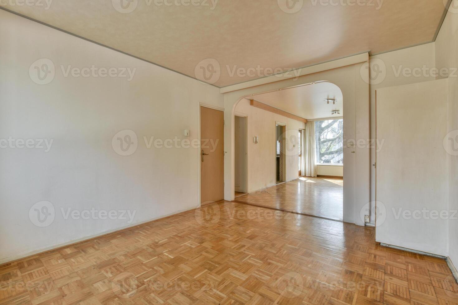 A room with a wooden floor and white walls photo