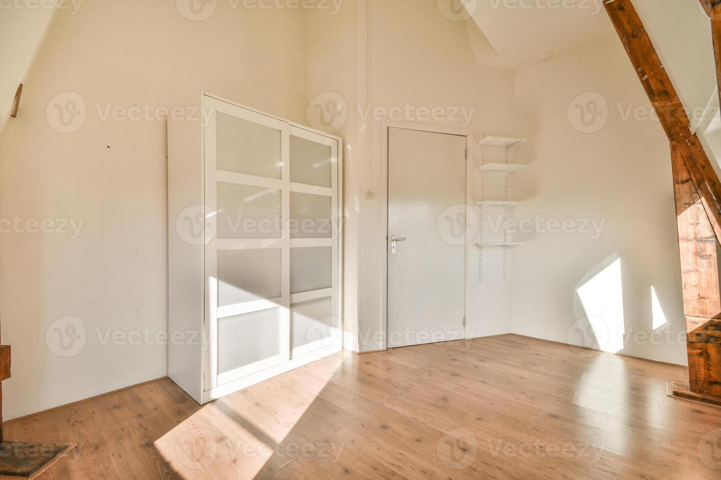 A room with a wooden floor and a door photo