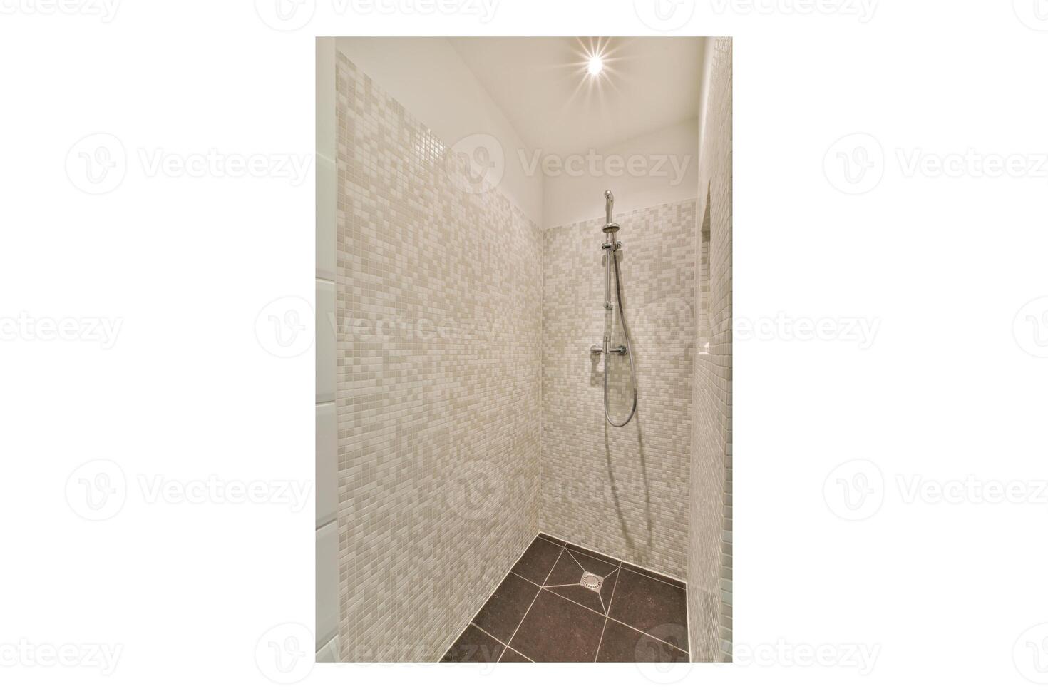 A shower with a shower head and a walk in shower photo