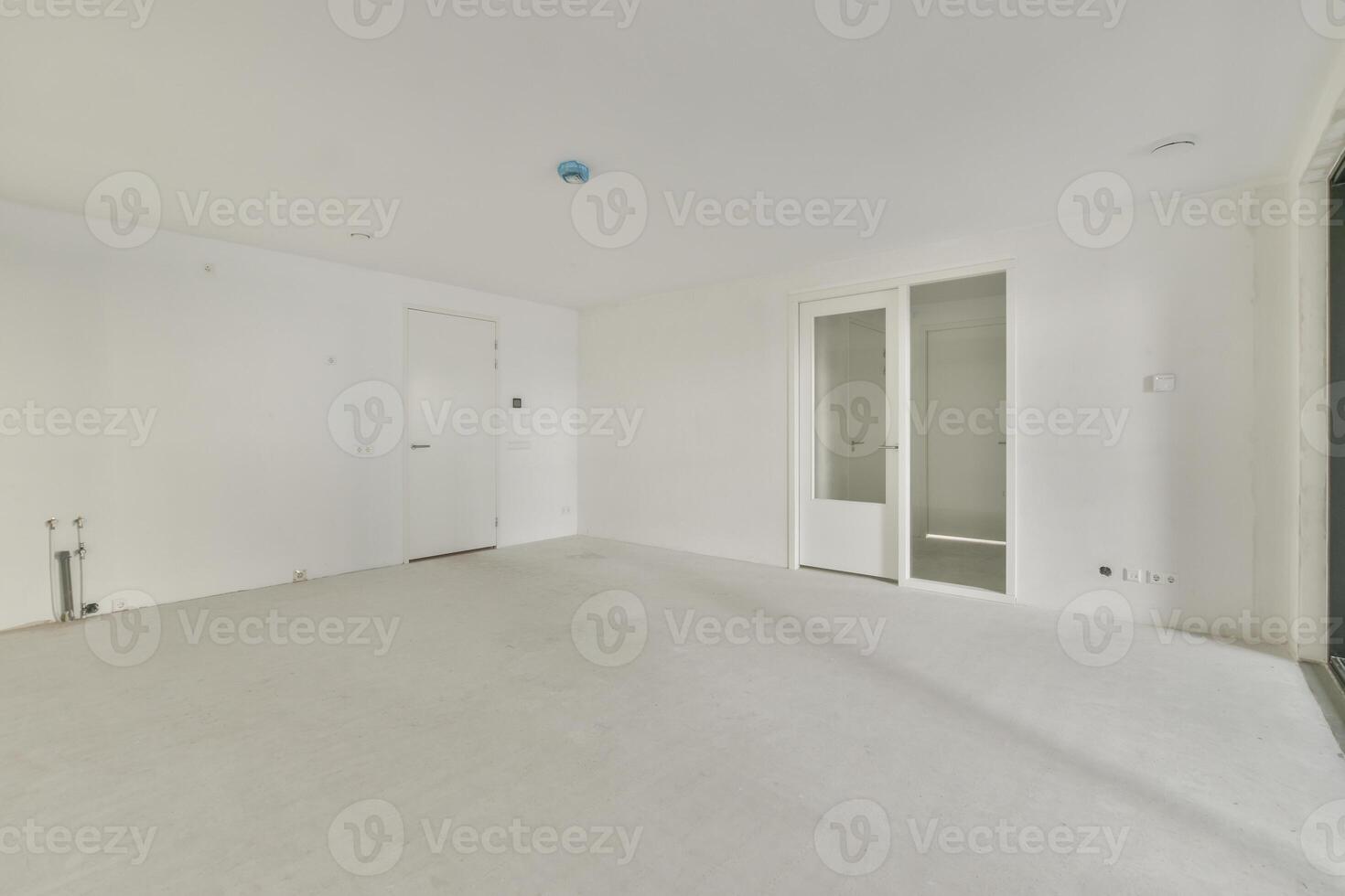 An empty room with white walls and a door photo