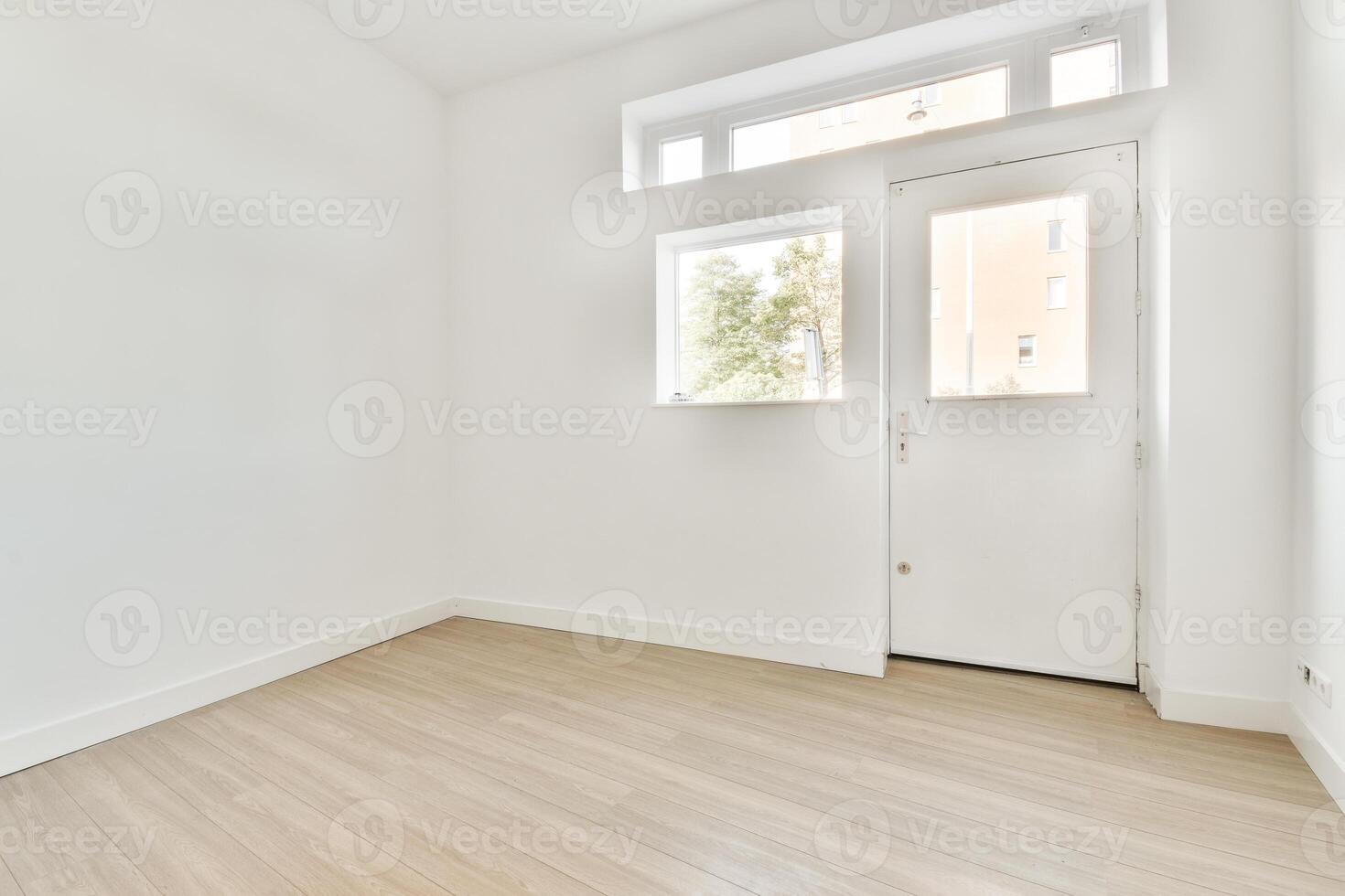 Empty room with white walls and wooden floors photo