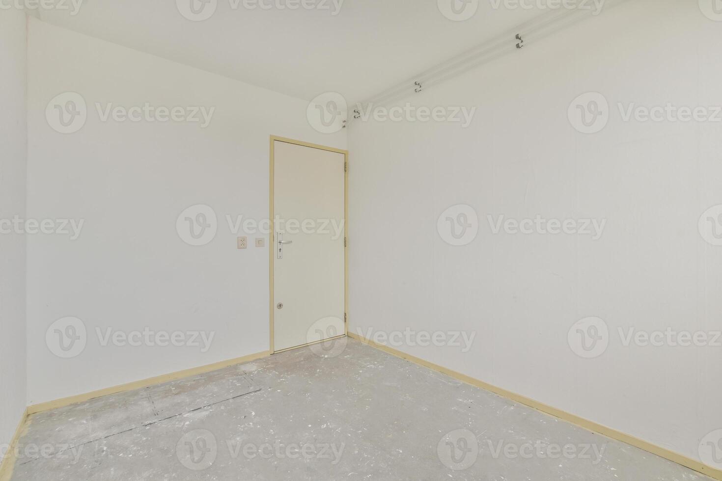 An empty room with a door and white walls photo