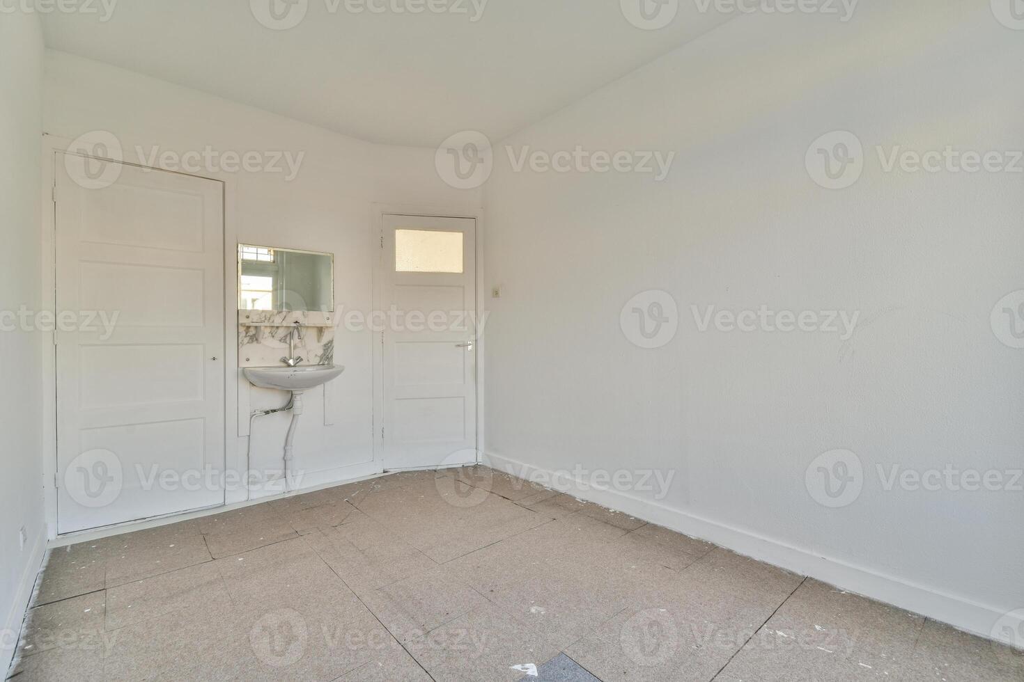 A bathroom with a sink and toilet in a white room photo