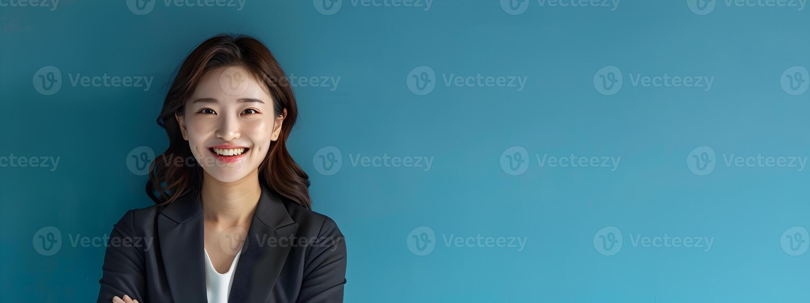 Confident and Accomplished Hallyu Businesswoman Stands in Stylish Suit Against Vibrant Blue Background photo