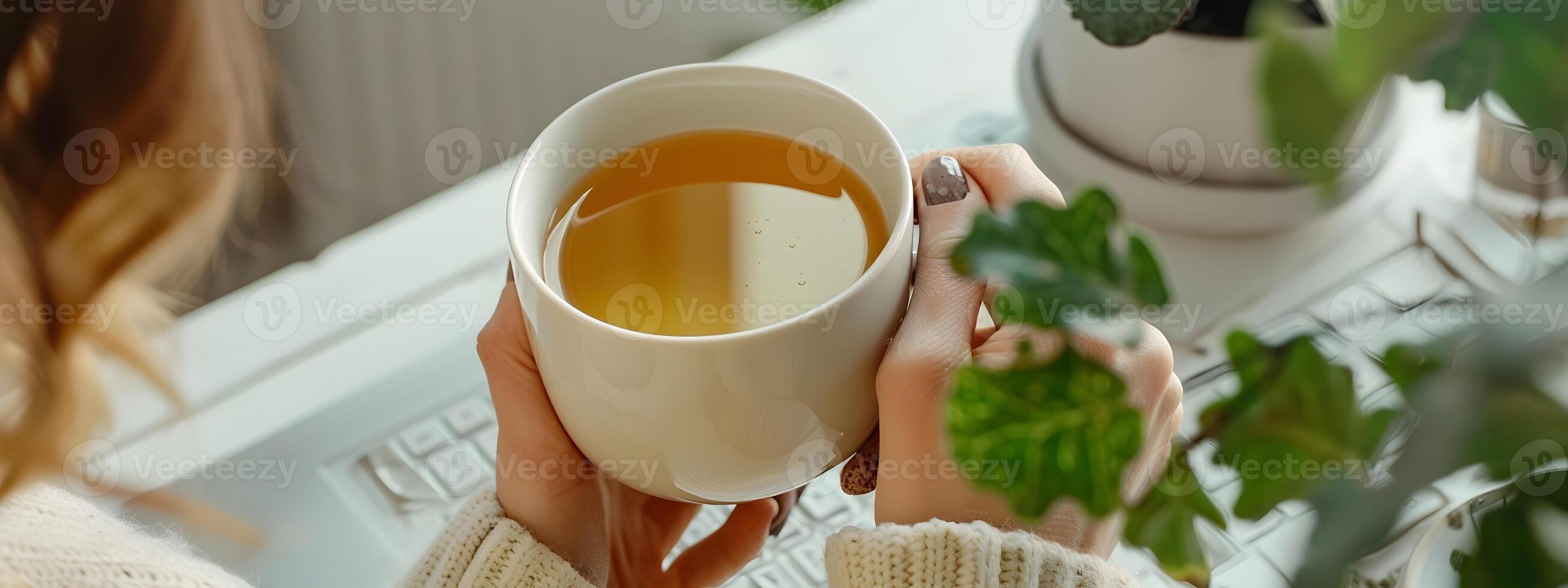 Woman Enjoying Herbal Tea in Peaceful Home Workspace photo