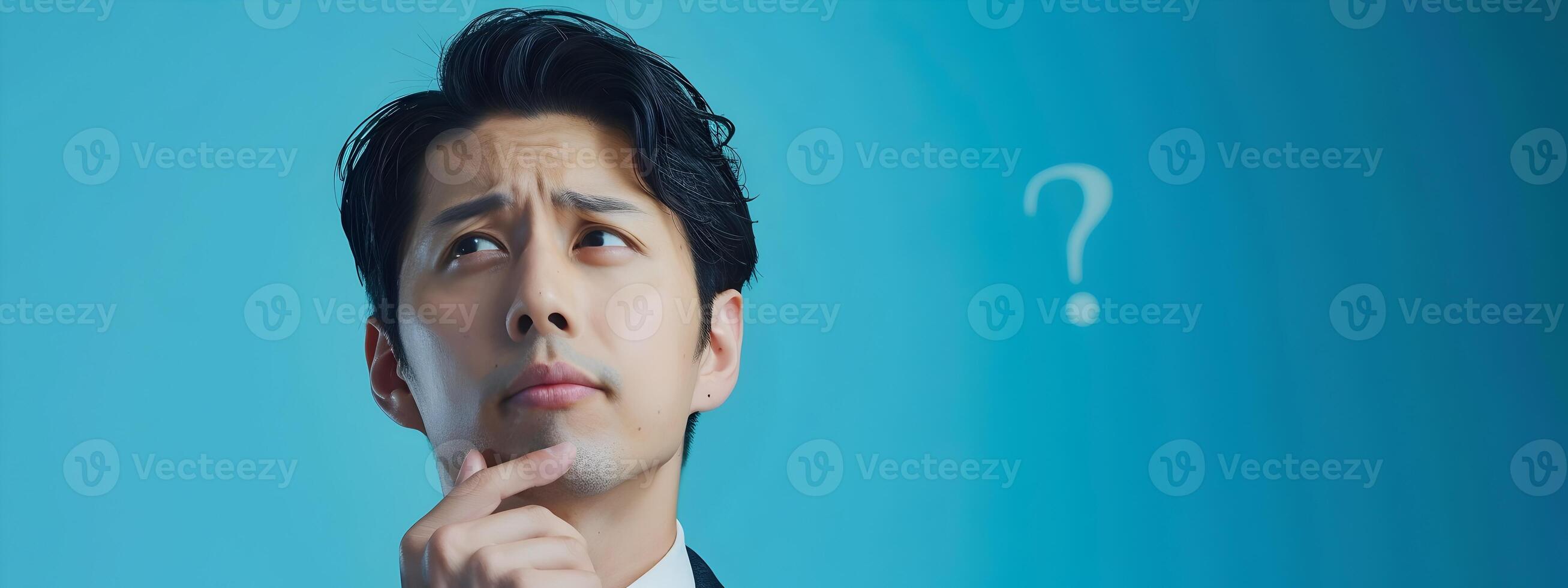 Asian Business Professional Pondering with Question Mark on Blue Background photo