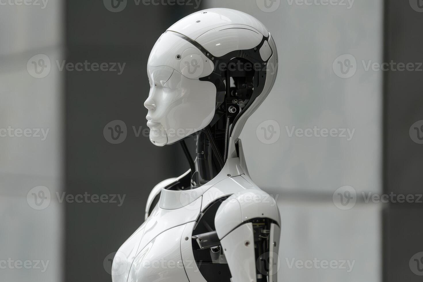 A white robot standing in front of a wall photo