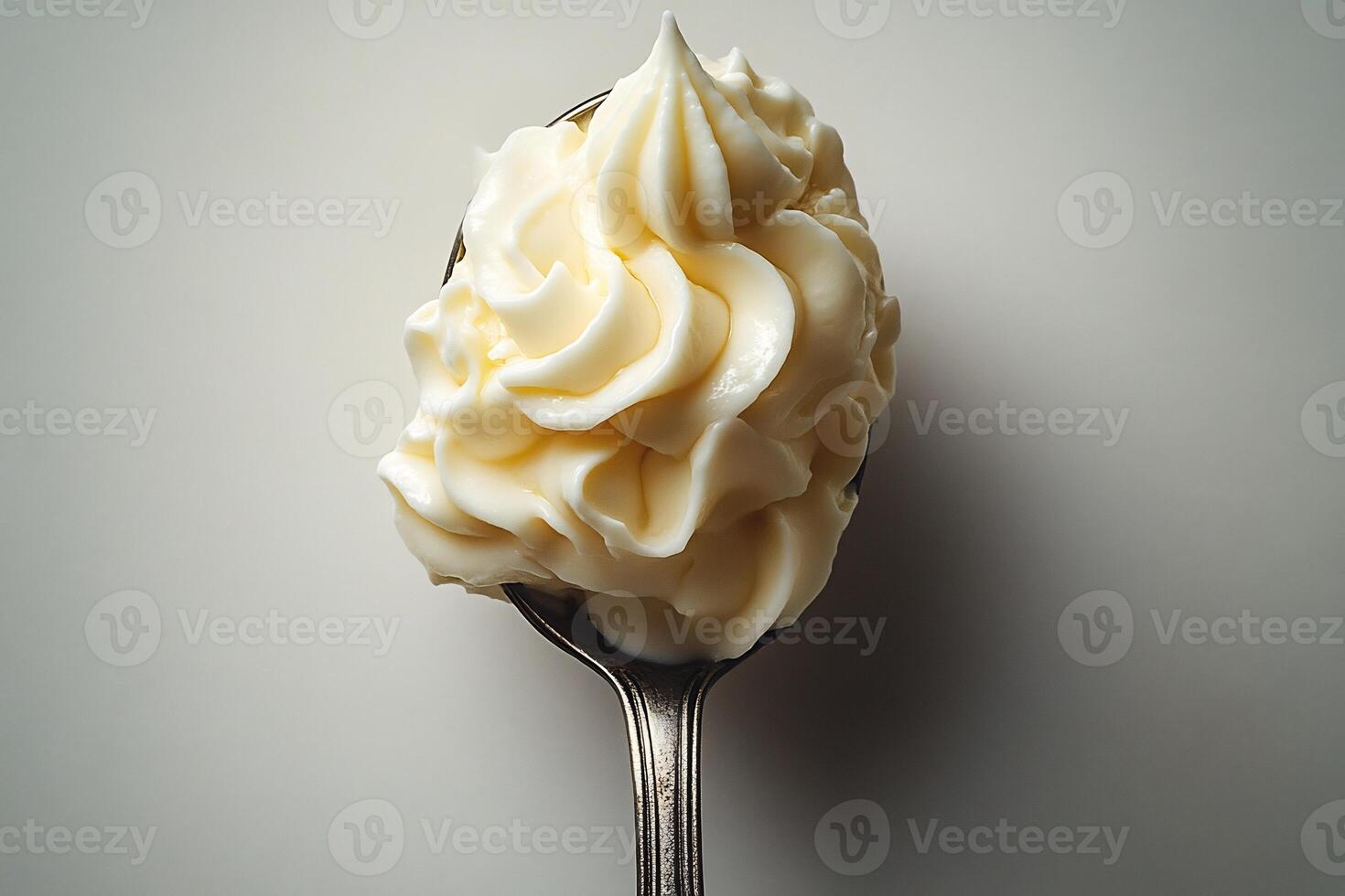 Spoonful of thick yogurt sauce placed in the center of a white background minimalistic and fresh photo