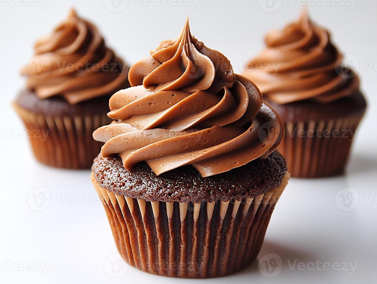 Swirl of chocolate frosting on a cupcake placed on a clean white background rich and decadent photo
