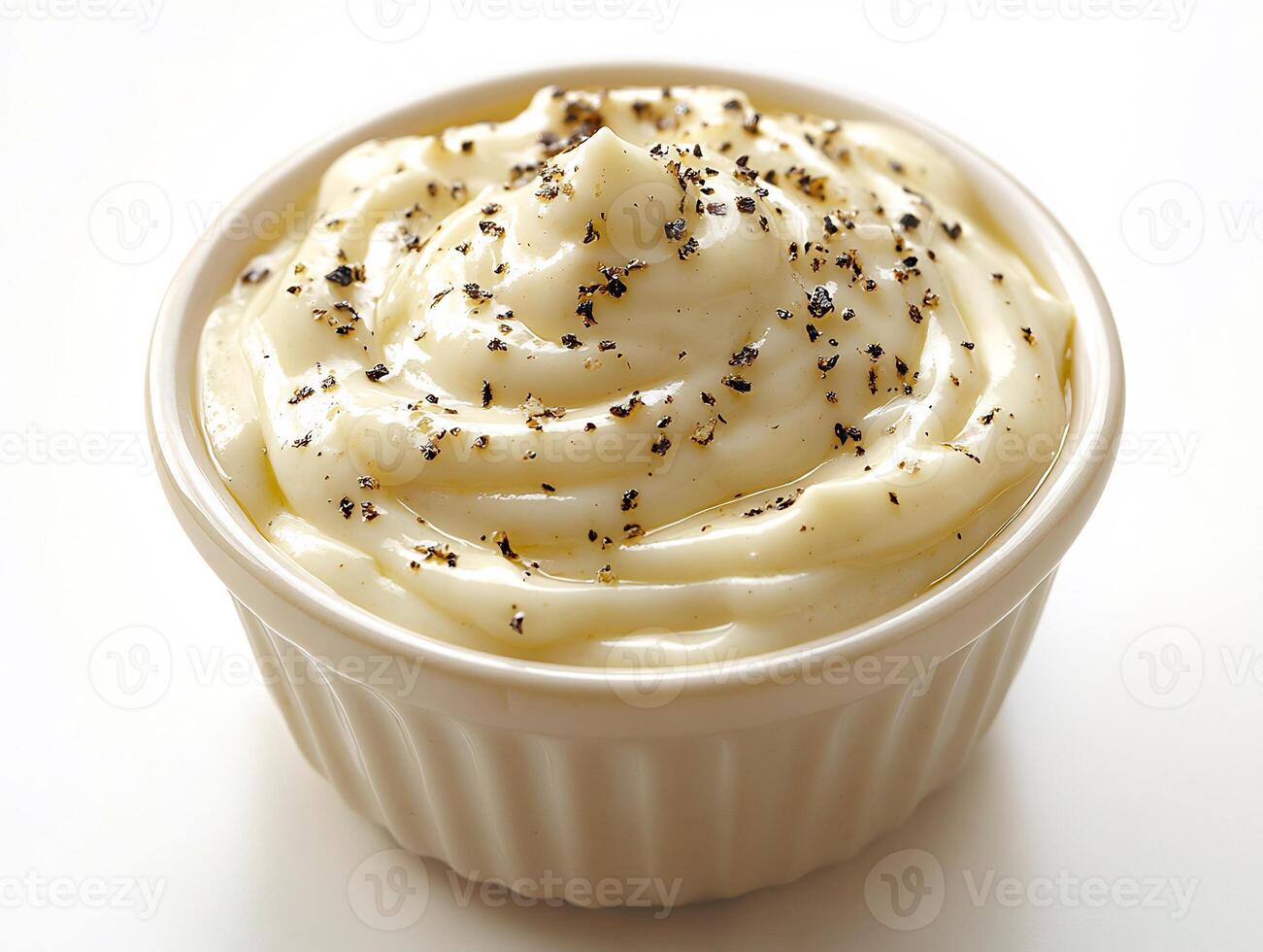 Creamy ranch sauce a small bowl with a drizzle of sauce splashed on the white background photo