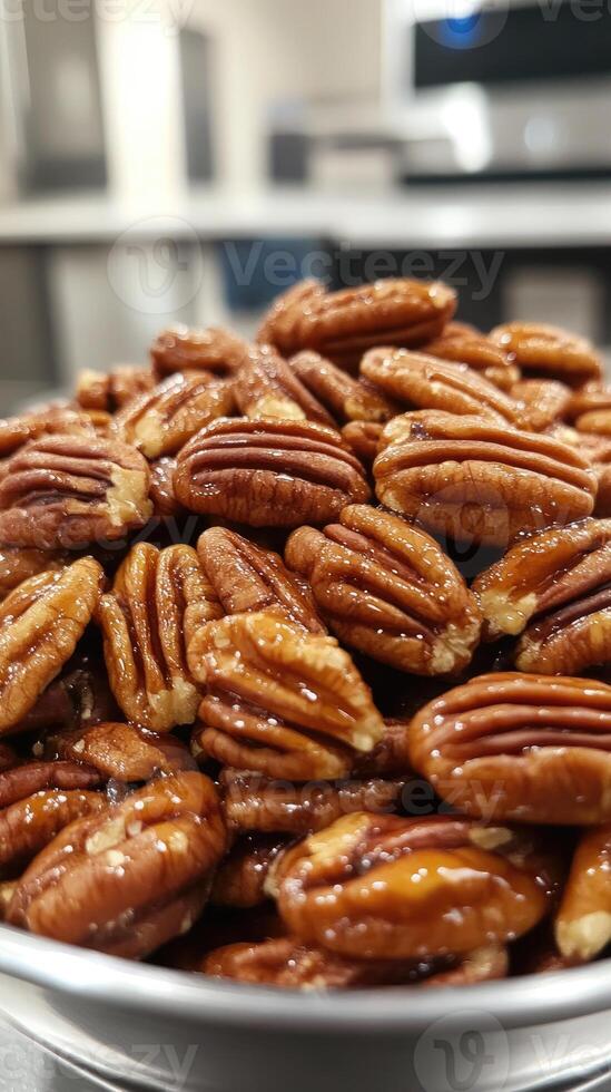 Bowl overflowing with delicious glazed pecans photo