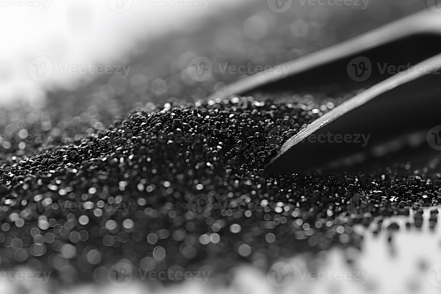 Close-Up of Black Sand with Shovel in Bokeh Effect Abstract Background for Design Projects photo
