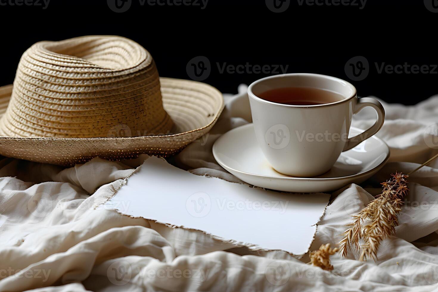 Rustic Breakfast Setting with Tea, Straw Hat, and Blank Note on White Fabric Cozy and Inviting Atmosphere photo