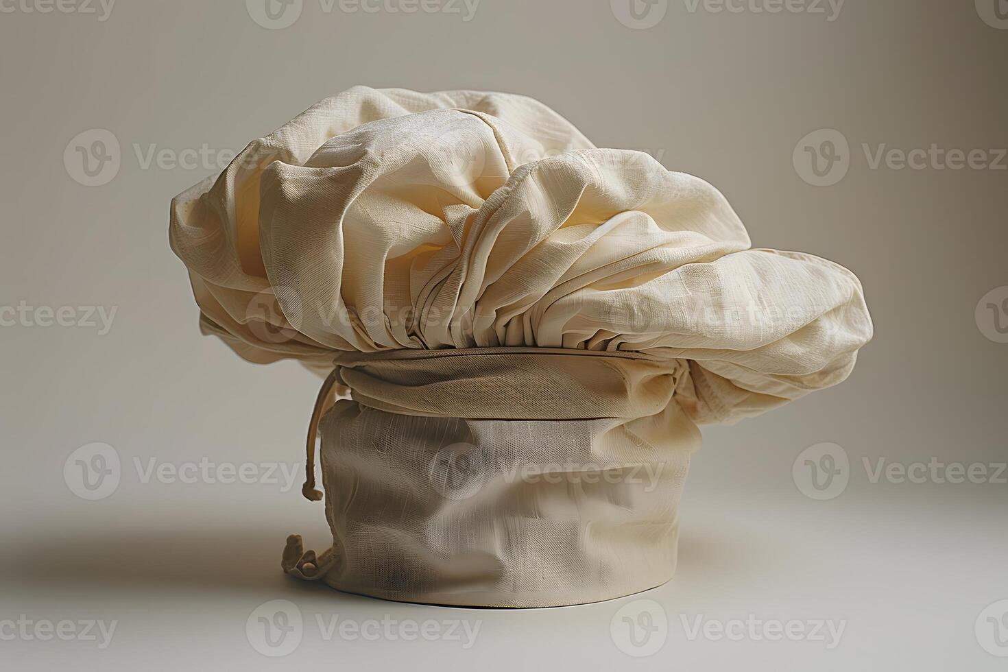 Elegant Beige Chef Hat with Drawstring on Neutral Background - Culinary and Professional Kitchen Apparel photo