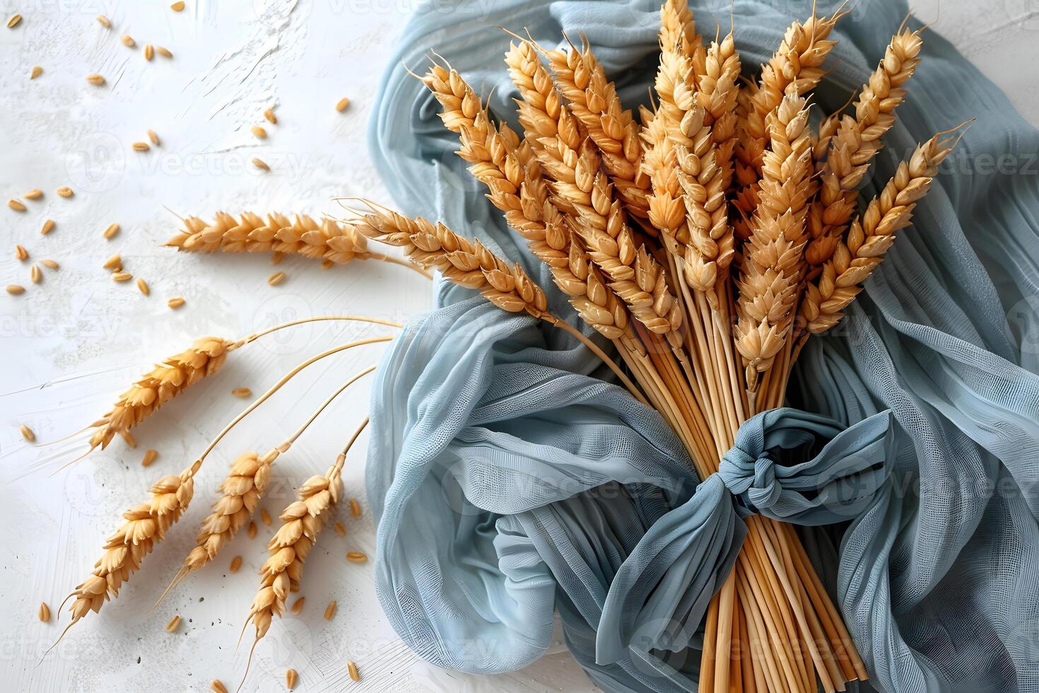 Autumn Harvest Concept Featuring Wheat Sheaves on Blue Fabric - Ideal for Agricultural and Seasonal Design photo
