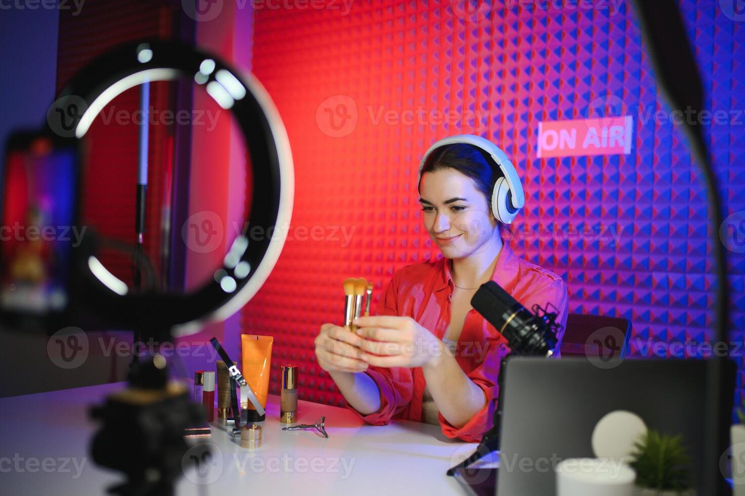 Young woman blogger recording on camera photo