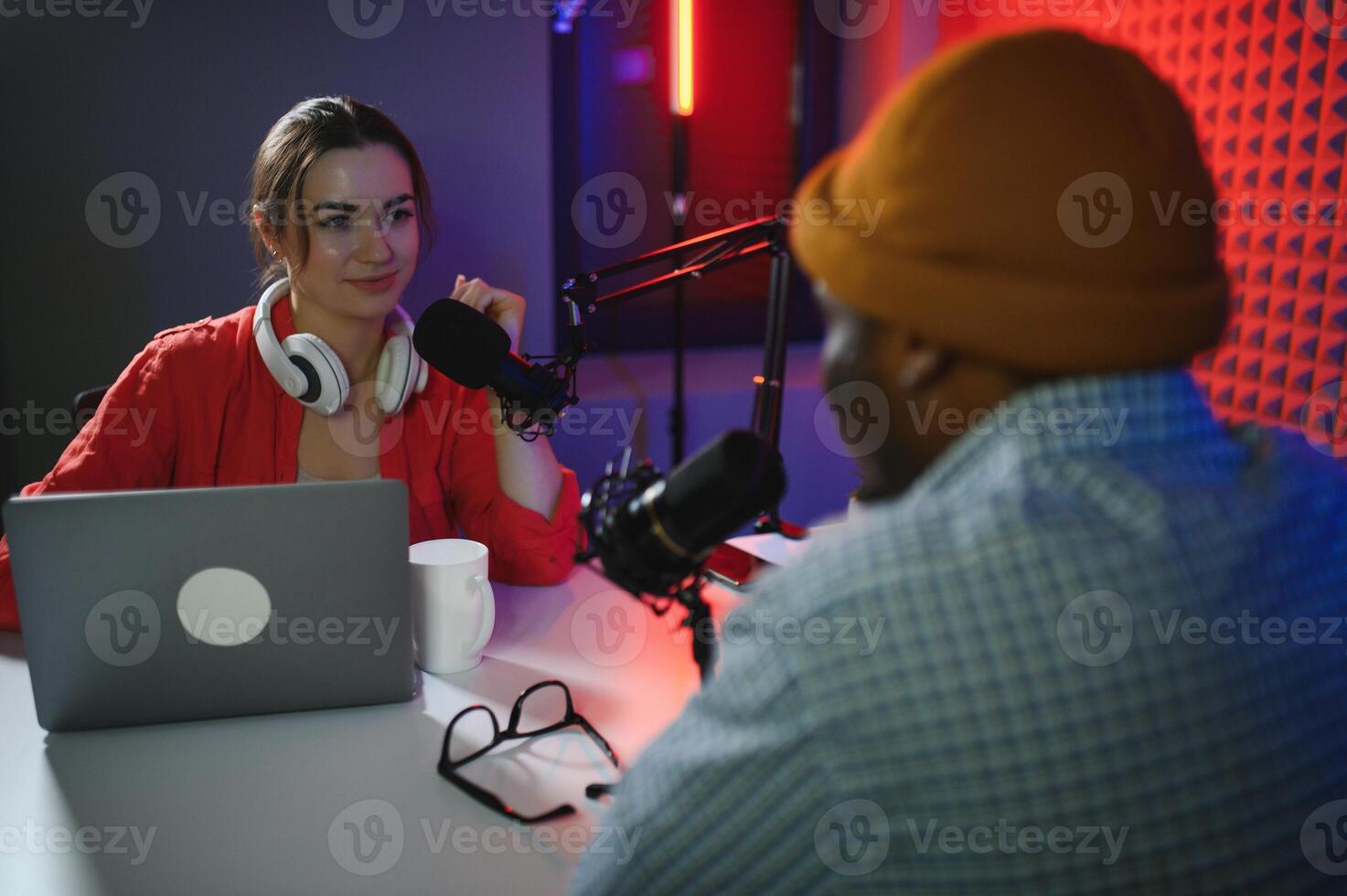 Man and woman livestreaming online discussion on podcast episode, recording live for internet content photo