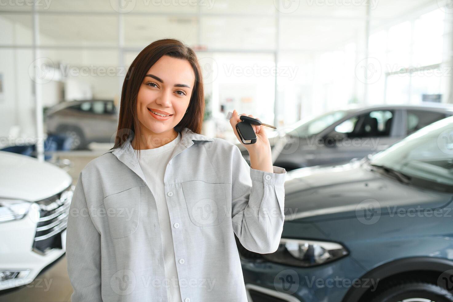 Young business woman choosing a car in a car salon photo