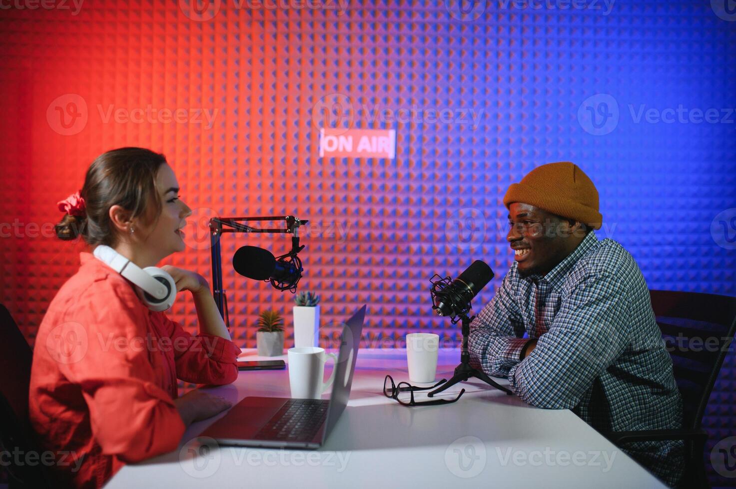 Man and woman livestreaming online discussion on podcast episode, recording live for internet content photo