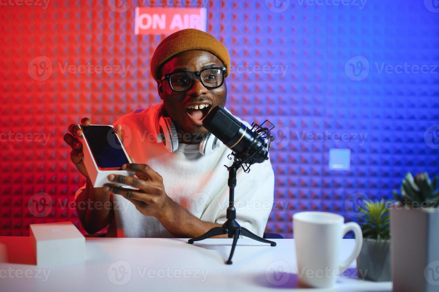 African american blogger unboxing new smartphone and recording on camera photo