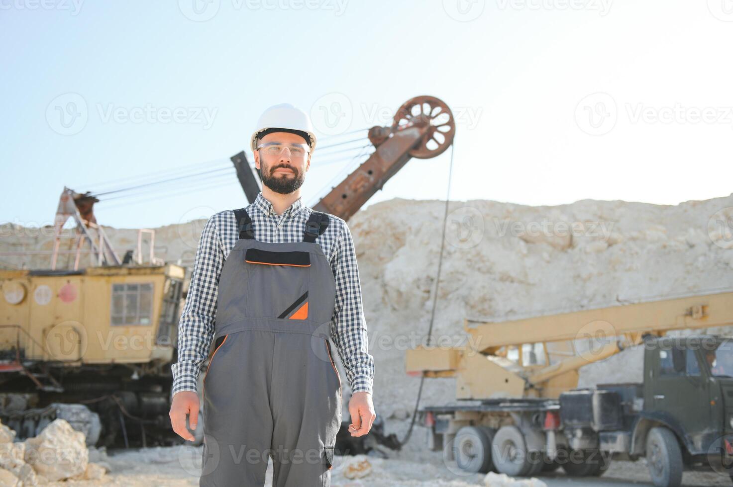 Worker and quarry in background photo