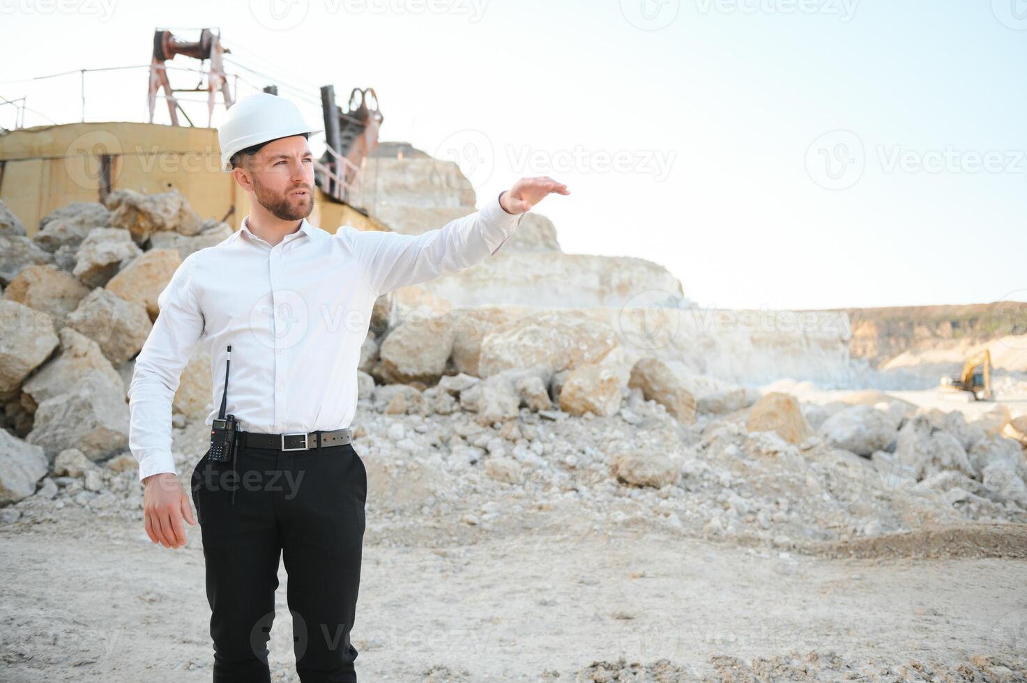 Extraction of stone. Male worker next to stone quarry. Engineer at construction site photo