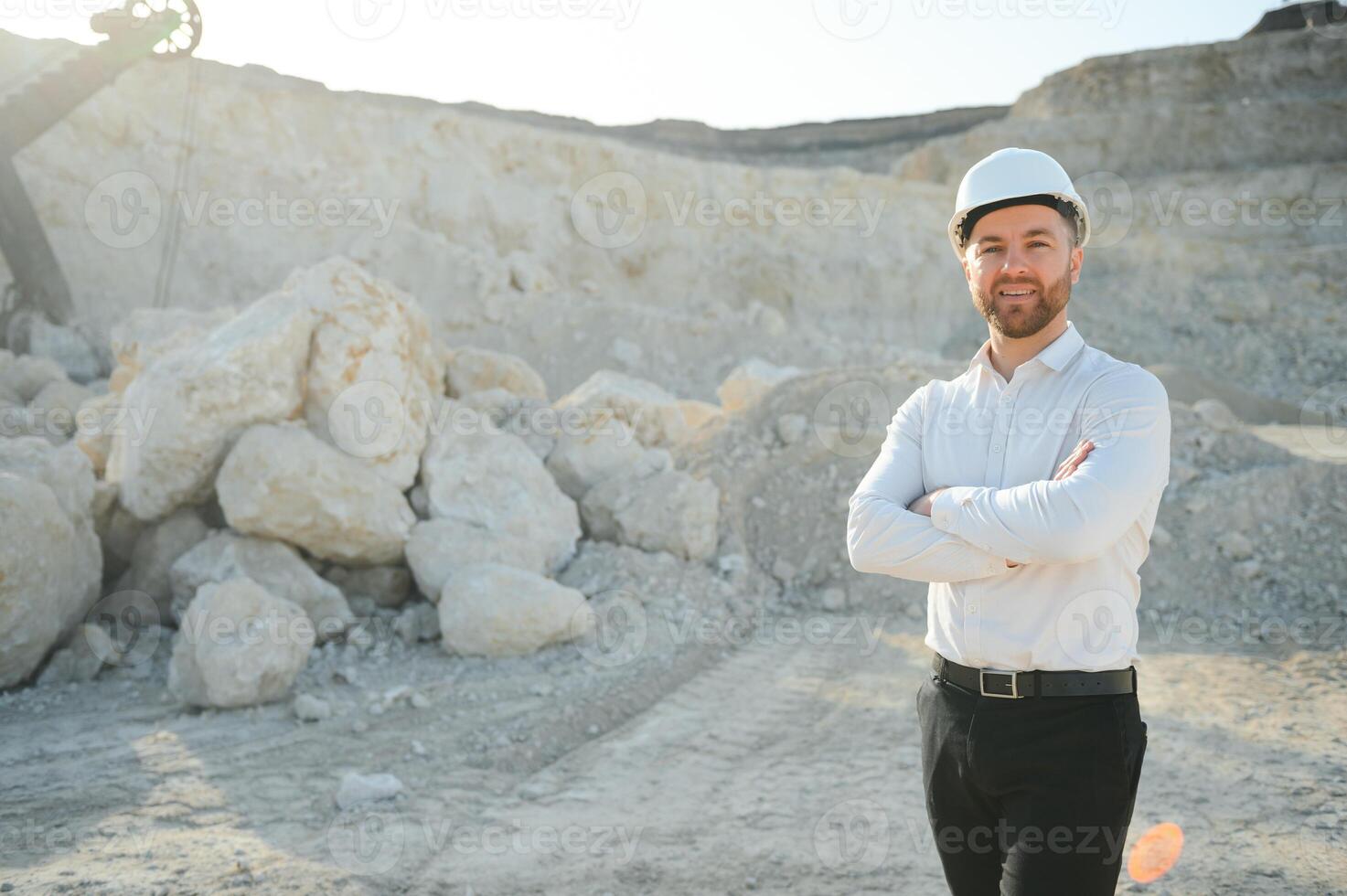 Extraction of stone. Male worker next to stone quarry. Engineer at construction site photo