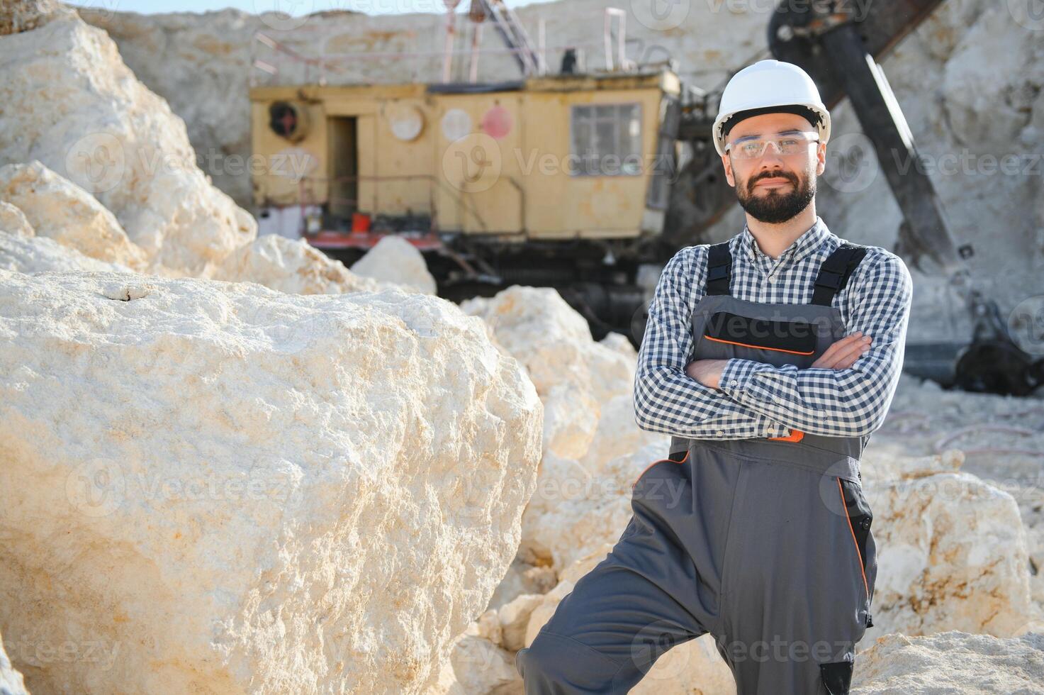 Extraction of stone. Male worker next to stone quarry. Engineer at construction site photo