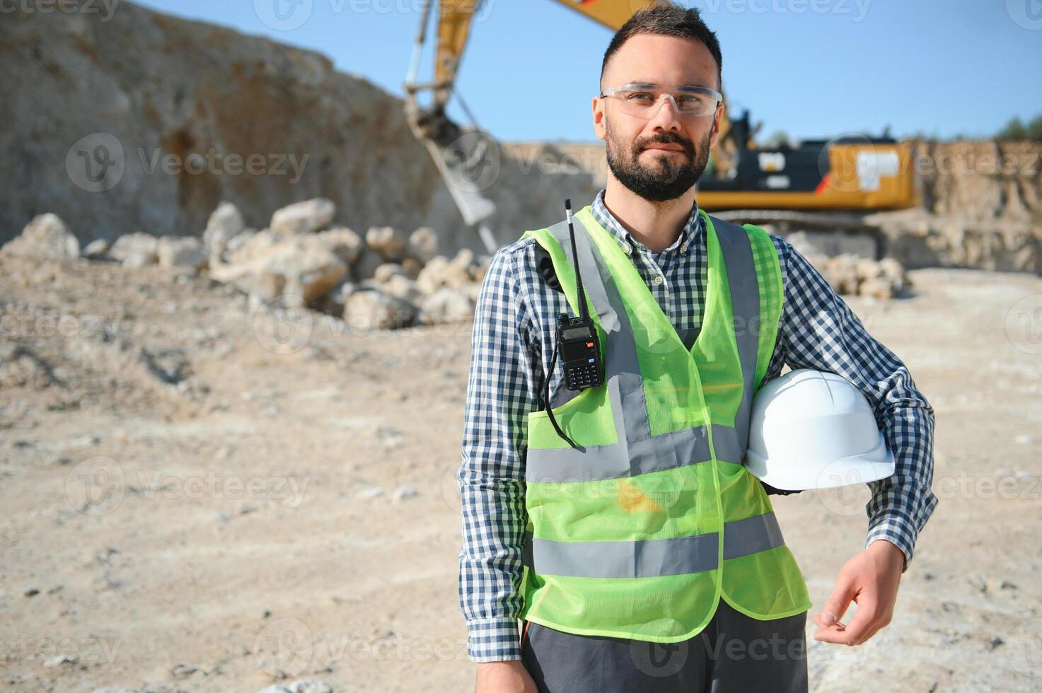 Worker and quarry in background photo